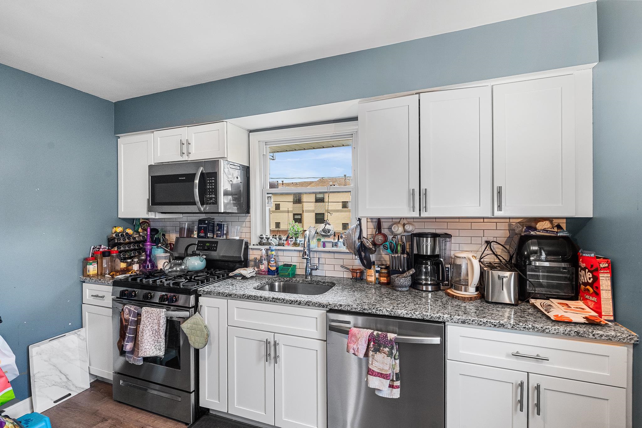 6 Mutillod Lane Secaucus, NJ 07094 - Photo 12 of 41 a kitchen with stainless steel appliances granite countertop a sink stove and microwave