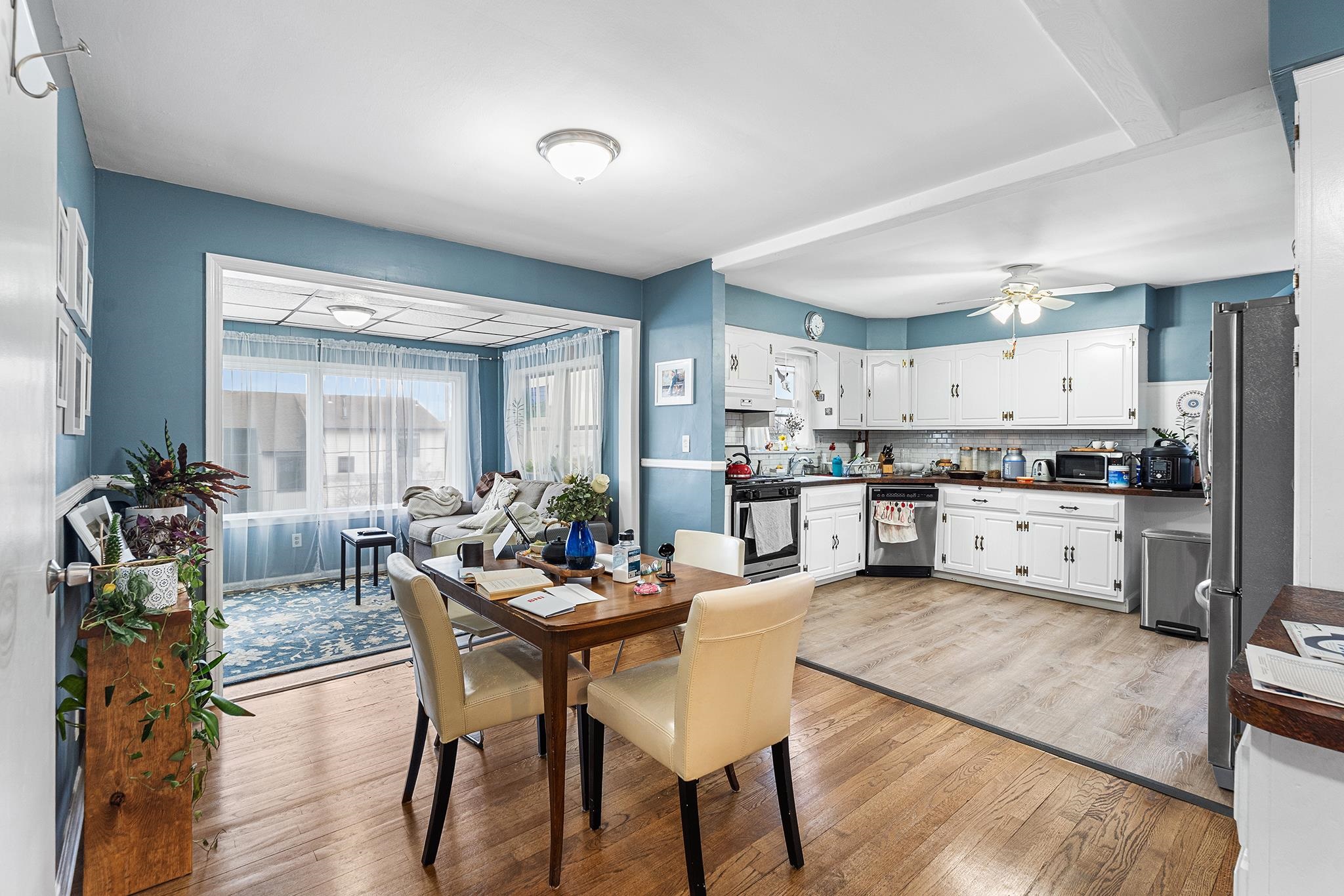 6 Mutillod Lane Secaucus, NJ 07094 - Photo 27 of 41 a kitchen with a dining table chairs and white cabinets