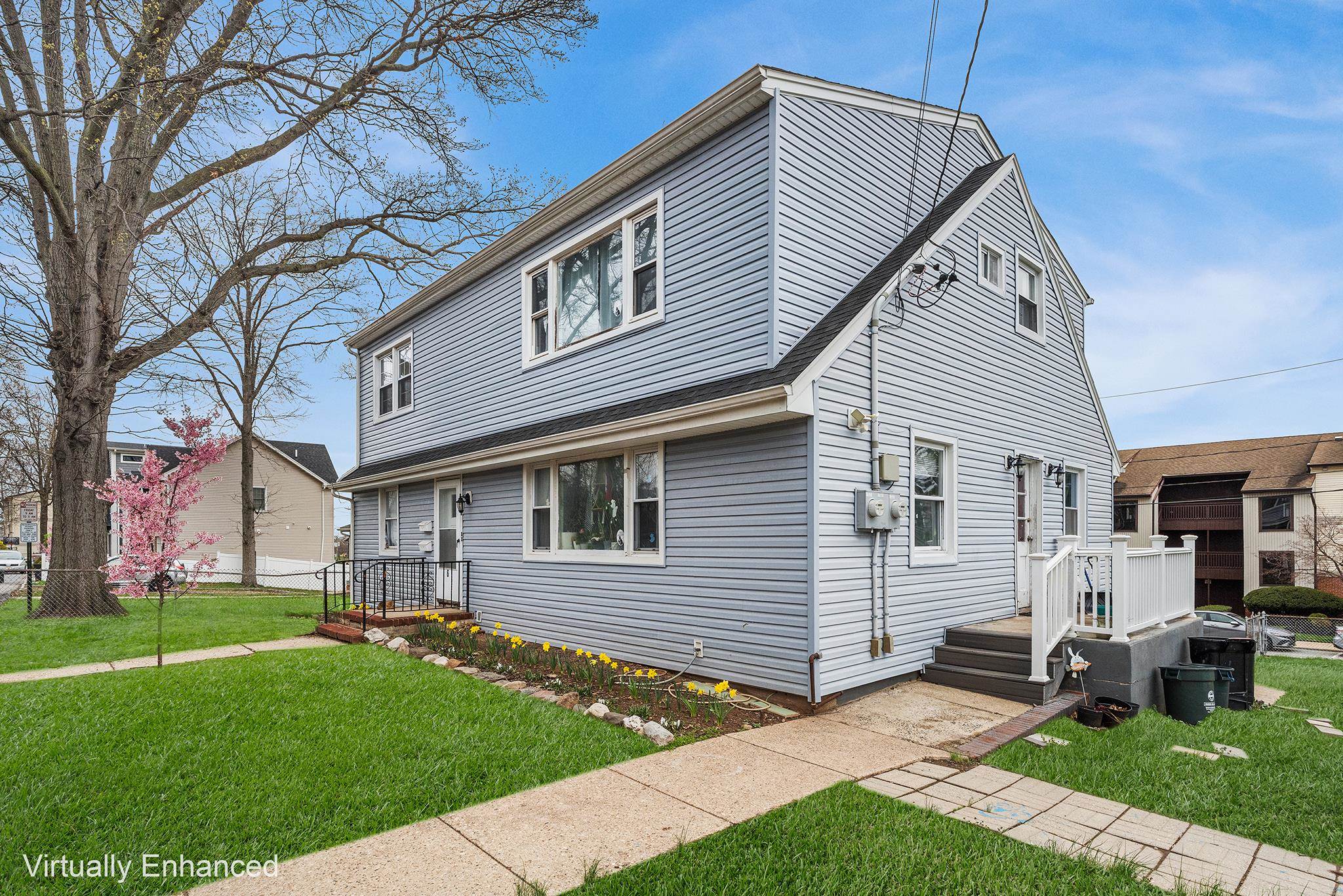 6 Mutillod Lane Secaucus, NJ 07094 - Photo 6 of 41 a front view of a house with a garden and trees