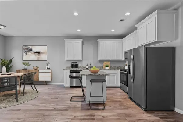 a kitchen with refrigerator and cabinets