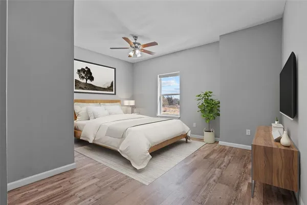 a bedroom with a bed chandelier and a window