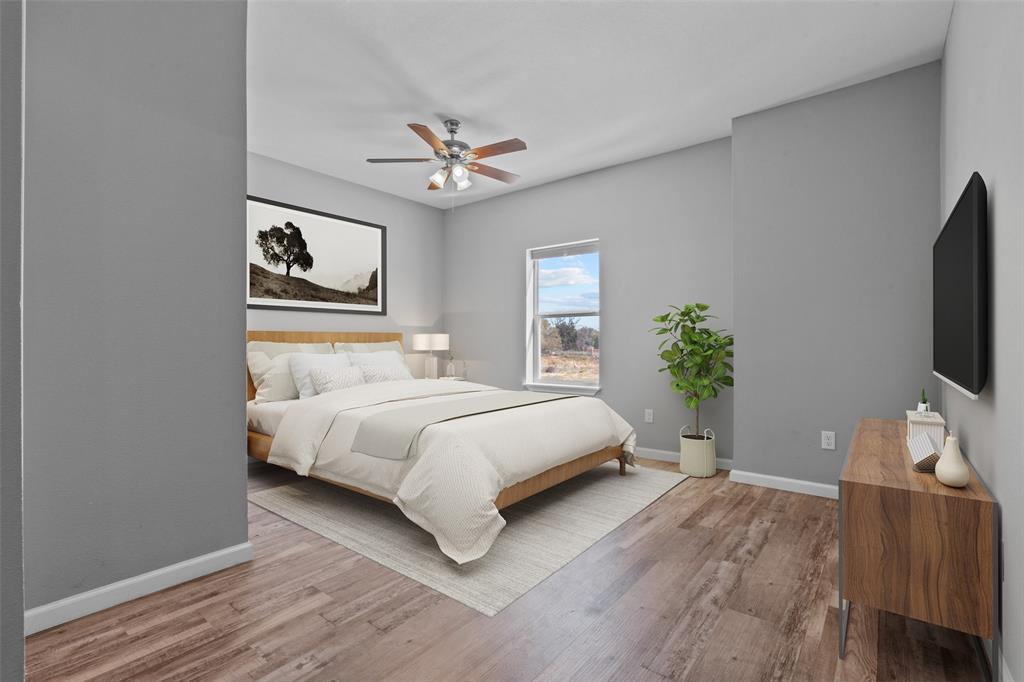 121 Winners Circle, Unit 102 Weatherford, TX 76087 - Photo 17 of 22 a bedroom with a bed chandelier and a window
