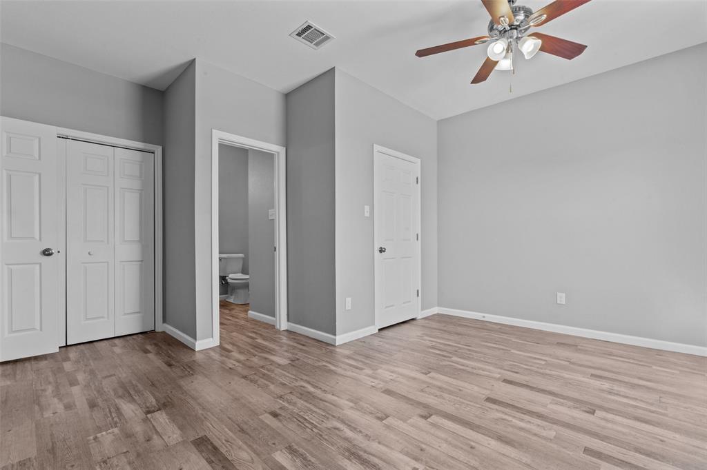 121 Winners Circle, Unit 102 Weatherford, TX 76087 - Photo 18 of 22 a view of an empty room with wooden floor