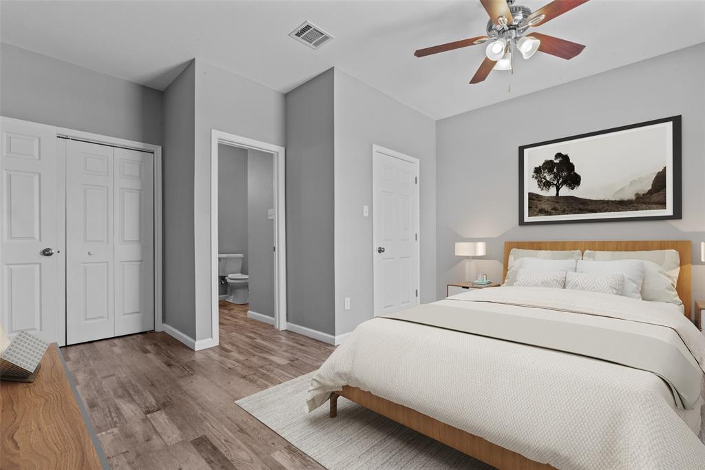 121 Winners Circle, Unit 102 Weatherford, TX 76087 - Photo 19 of 22 a bedroom with a bed and a chandelier