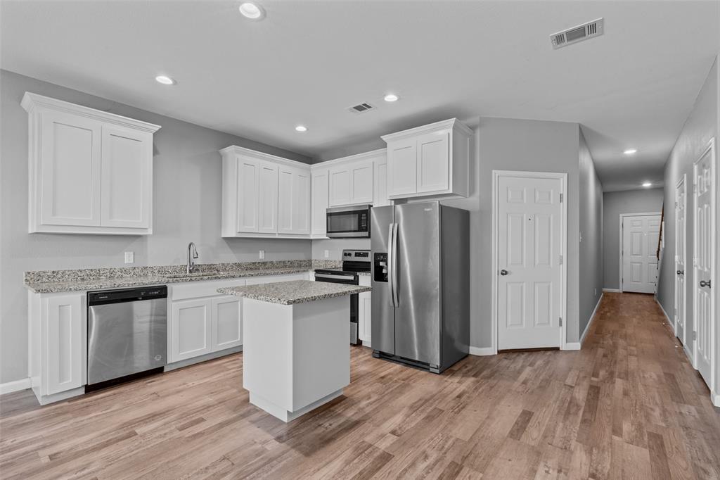 121 Winners Circle, Unit 102 Weatherford, TX 76087 - Photo 3 of 22 a kitchen with stainless steel appliances granite countertop a refrigerator and a stove top oven