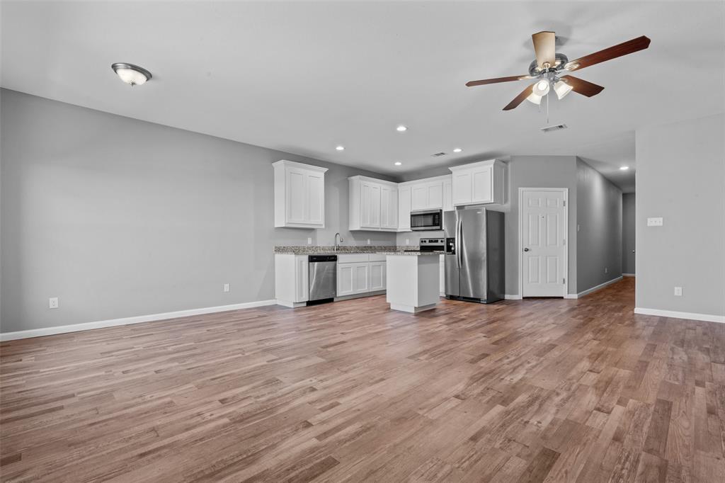 121 Winners Circle, Unit 102 Weatherford, TX 76087 - Photo 6 of 22 a view of kitchen with stainless steel appliances refrigerator stove microwave and cabinets