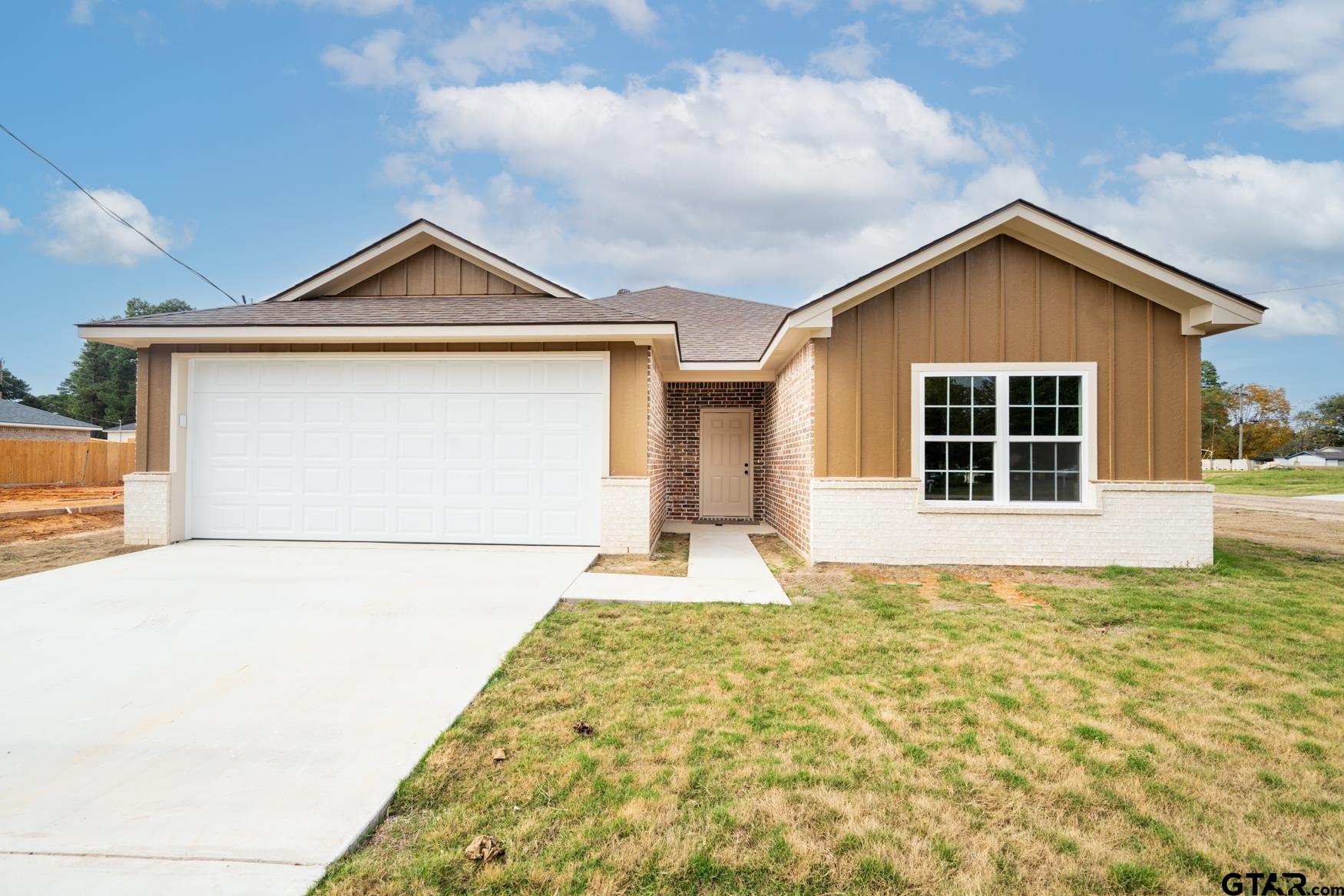 a front view of a house with garage