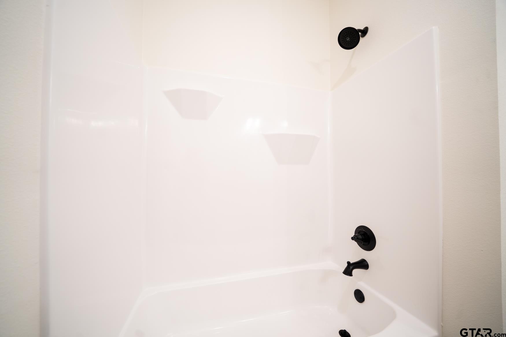 309 Stevens Street Gilmer, TX 75645 - Photo 15 of 28 a bathroom with a bathtub