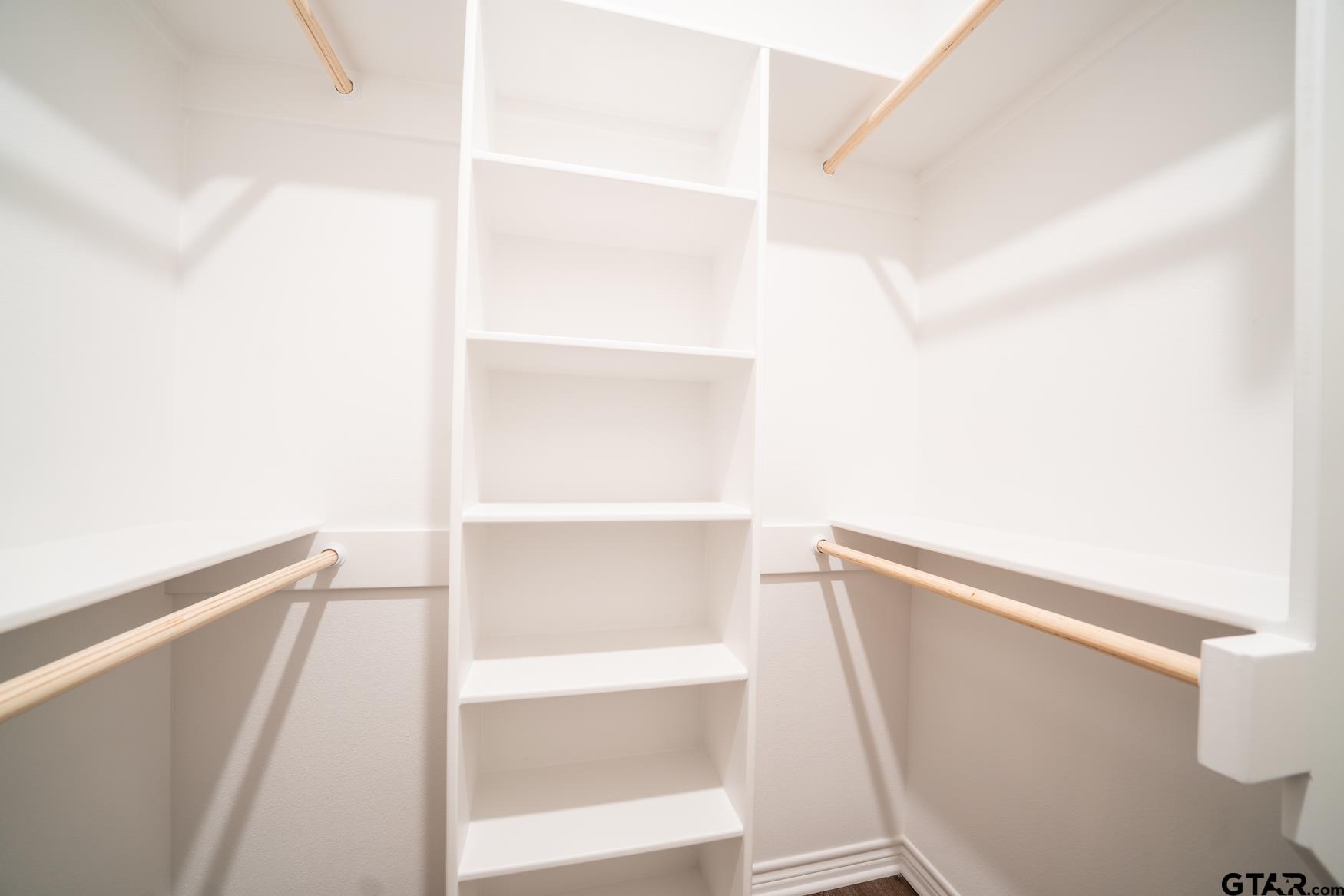 309 Stevens Street Gilmer, TX 75645 - Photo 19 of 28 a view of walk in closet with empty racks