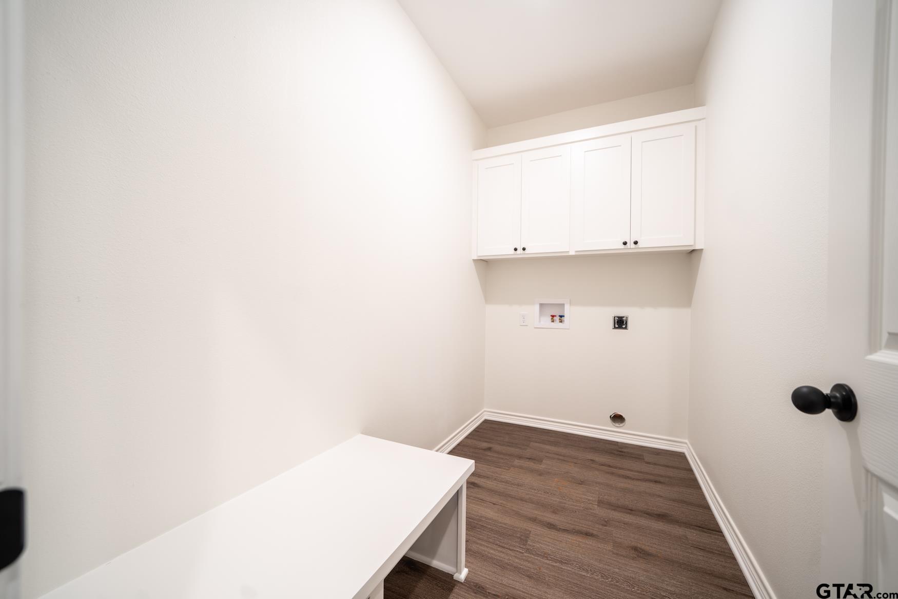 309 Stevens Street Gilmer, TX 75645 - Photo 21 of 28 a view of a room with wooden floor and cabinet