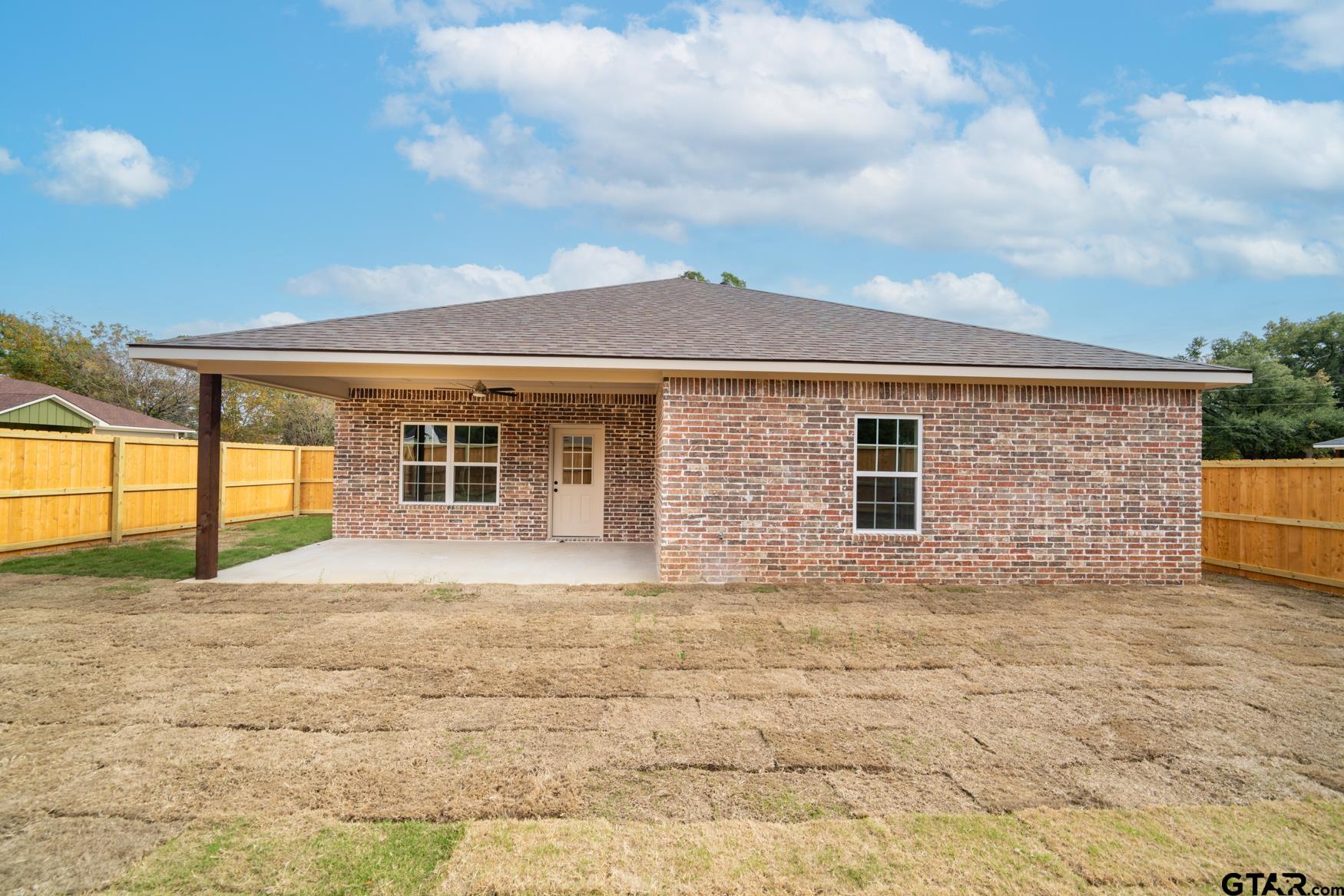 309 Stevens Street Gilmer, TX 75645 - Photo 24 of 28 a front view of a house with a yard