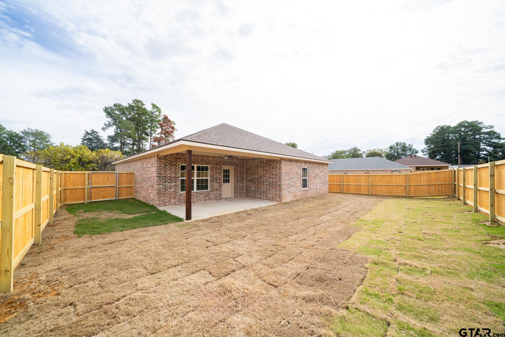 309 Stevens Street Gilmer, TX 75645 - Photo 25 of 28 a view of a house with a yard