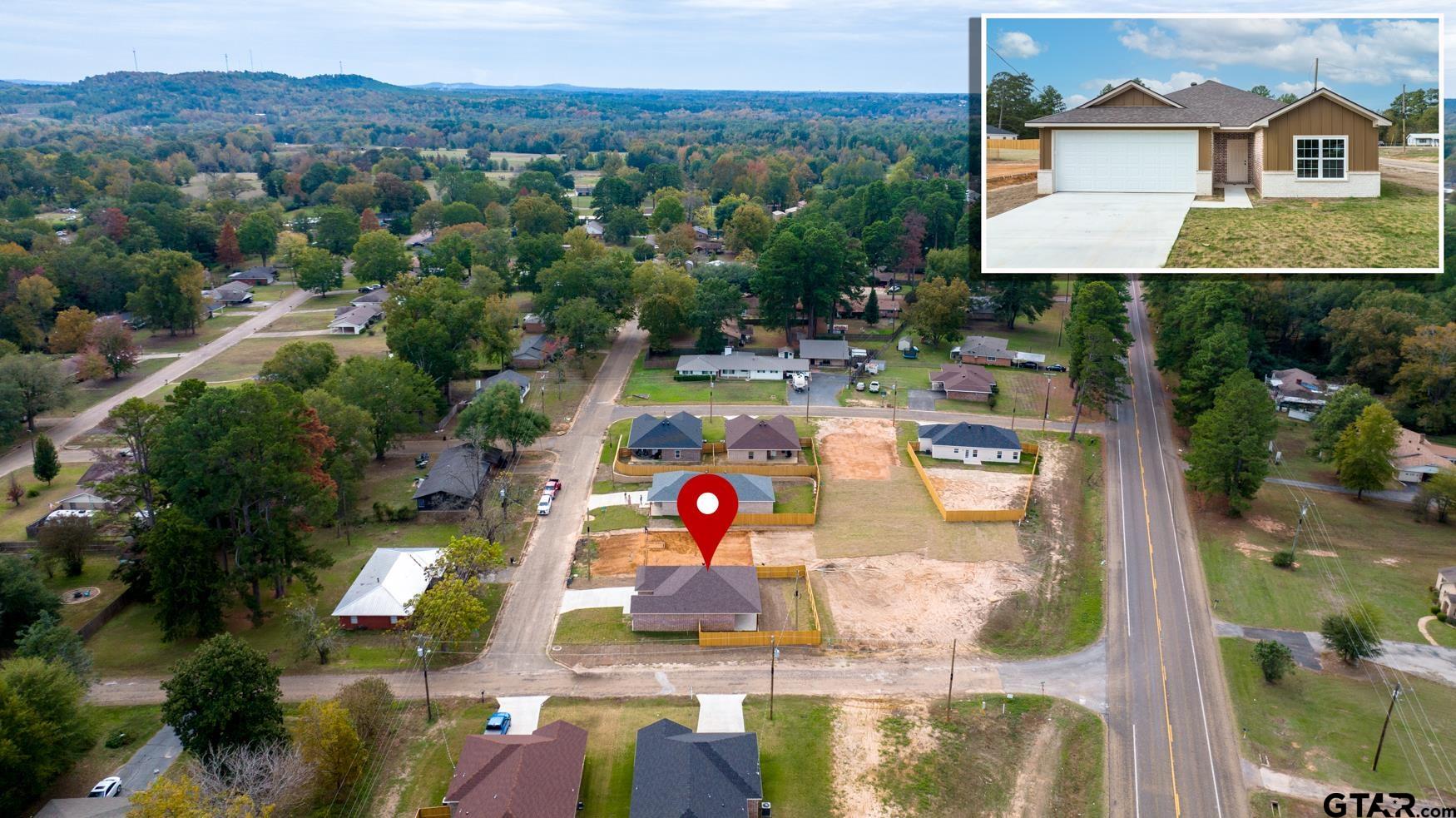 309 Stevens Street Gilmer, TX 75645 - Photo 28 of 28 an aerial view of residential houses with outdoor space and swimming pool
