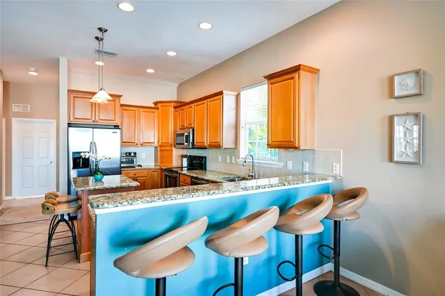 a kitchen with a table chairs sink and cabinets