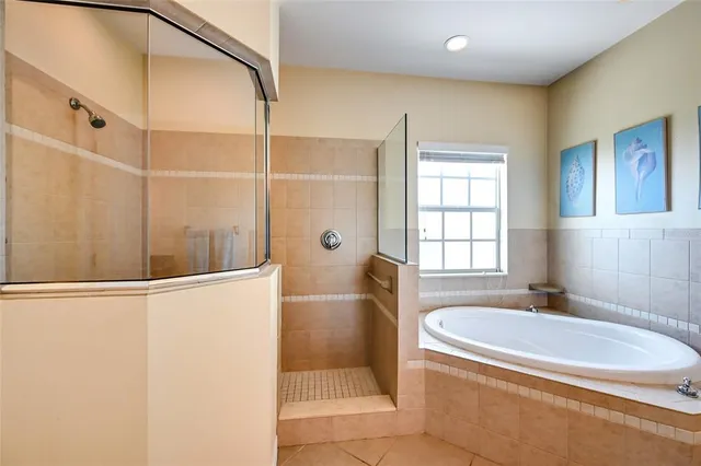 a bathroom with a granite countertop sink a mirror and a bathtub
