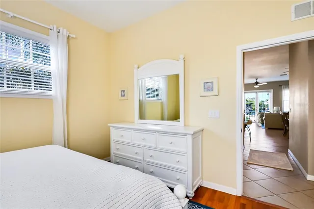 a bedroom with a bed and a mirror