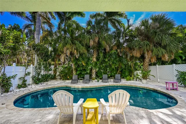 a view of swimming pool with outdoor seating and plants