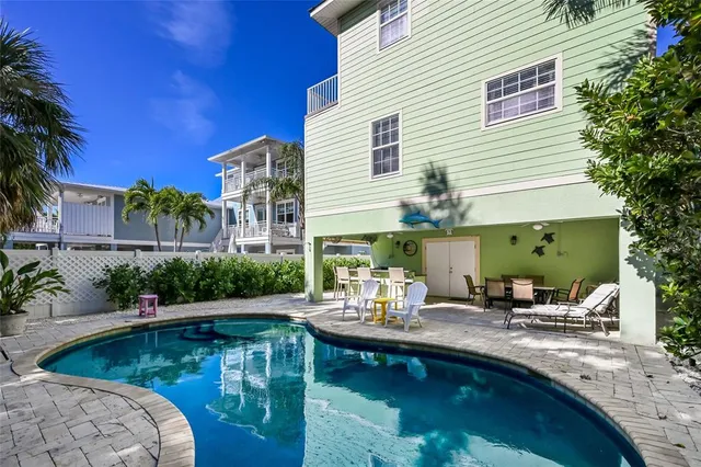 a view of swimming pool with outdoor seating