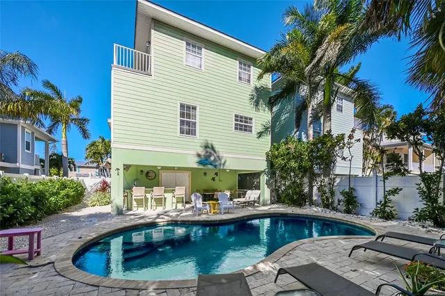 a view of a swimming pool with chairs