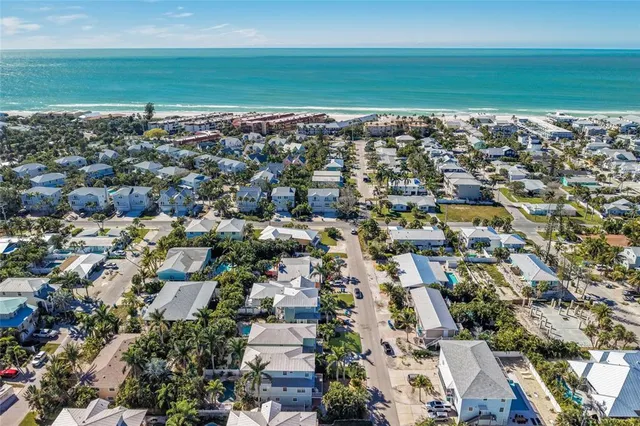 an aerial view of a city with ocean view