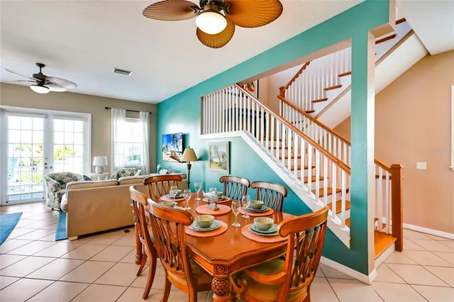 a dining room with furniture and a chandelier