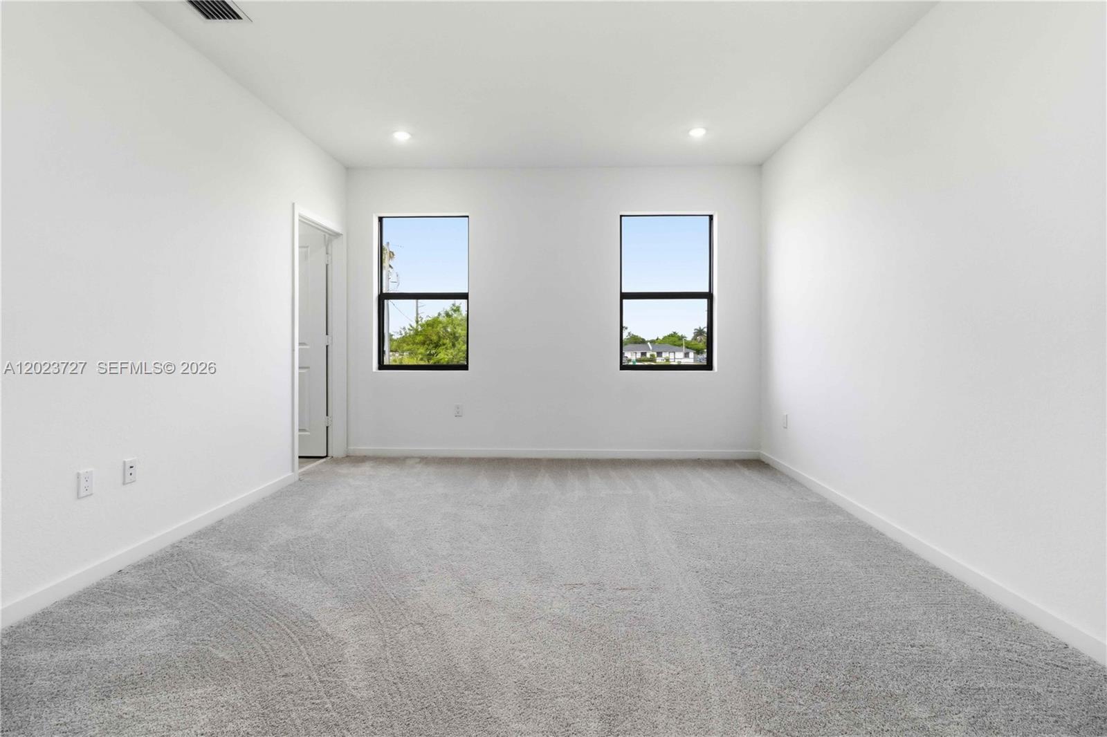22348 Southwest 115th Court, Unit 22348 Miami, FL 33170 - Photo 18 of 37 an empty room with windows and closet