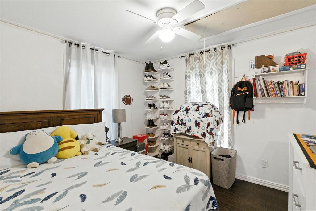 116 West 7th Street Weatherford, TX 76086 - Photo 11 of 26 a bedroom with a bed and a dresser