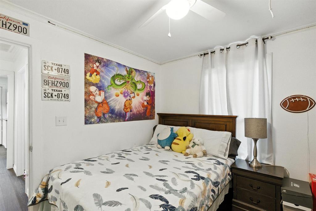 116 West 7th Street Weatherford, TX 76086 - Photo 14 of 26 a bed sitting in a bedroom next to a cabinet