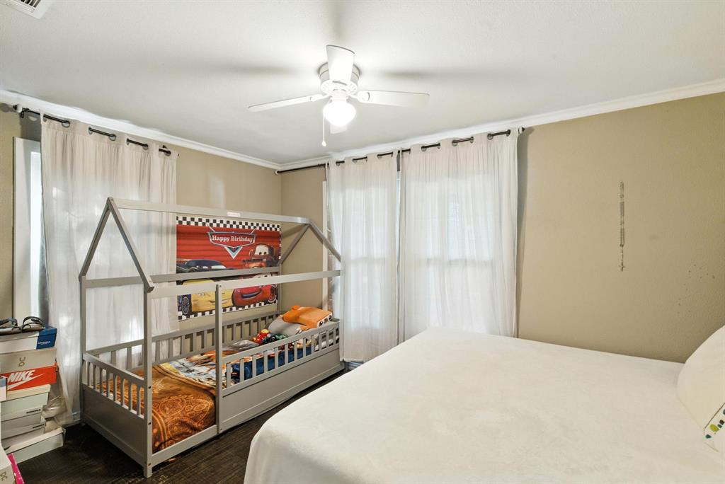 116 West 7th Street Weatherford, TX 76086 - Photo 19 of 26 a bedroom with furniture and a window
