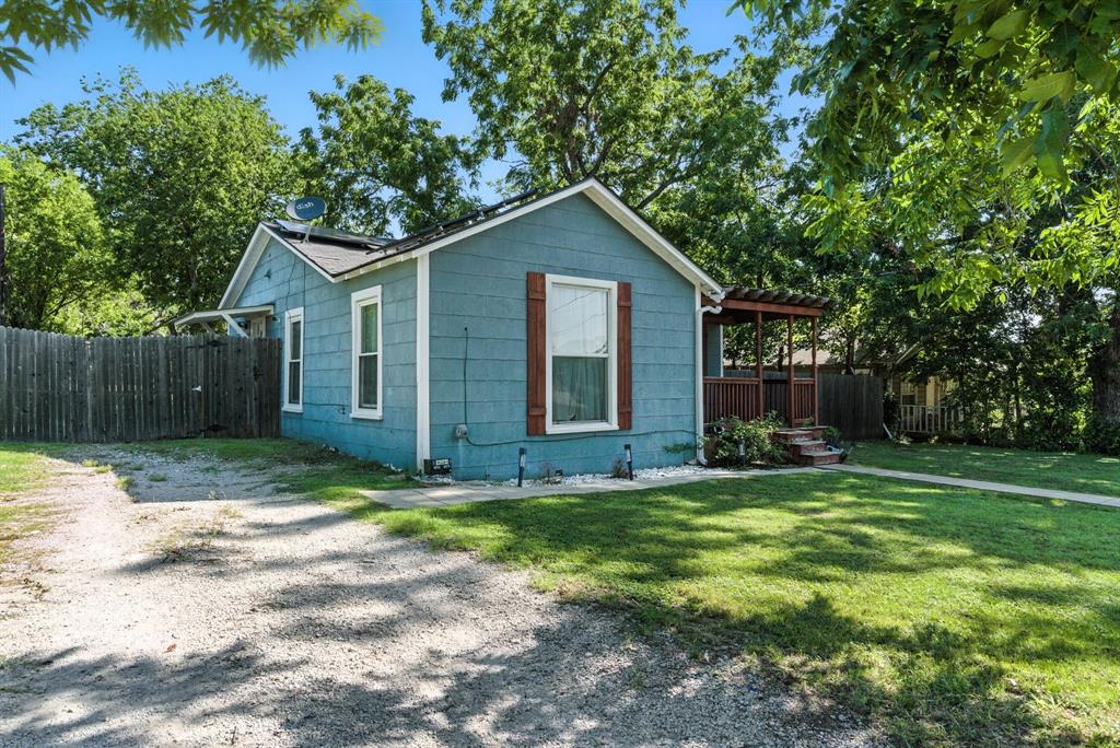 116 West 7th Street Weatherford, TX 76086 - Photo 3 of 26 a view of a house with yard and a garden