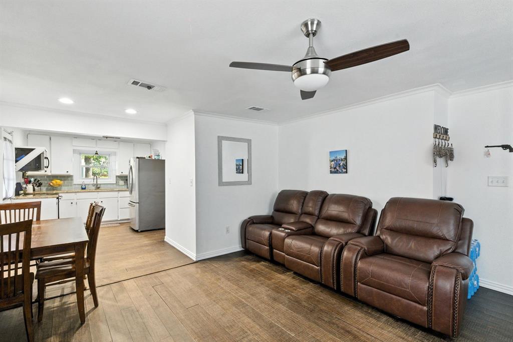 116 West 7th Street Weatherford, TX 76086 - Photo 7 of 26 a living room with furniture a ceiling fan and a rug