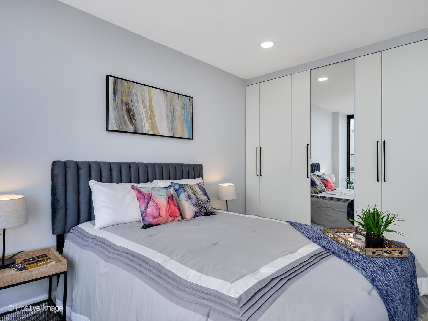 5455 North Sheridan Road, Unit 3906 Chicago, IL 60640 - Photo 13 of 24 a bedroom with a bed and a lamp