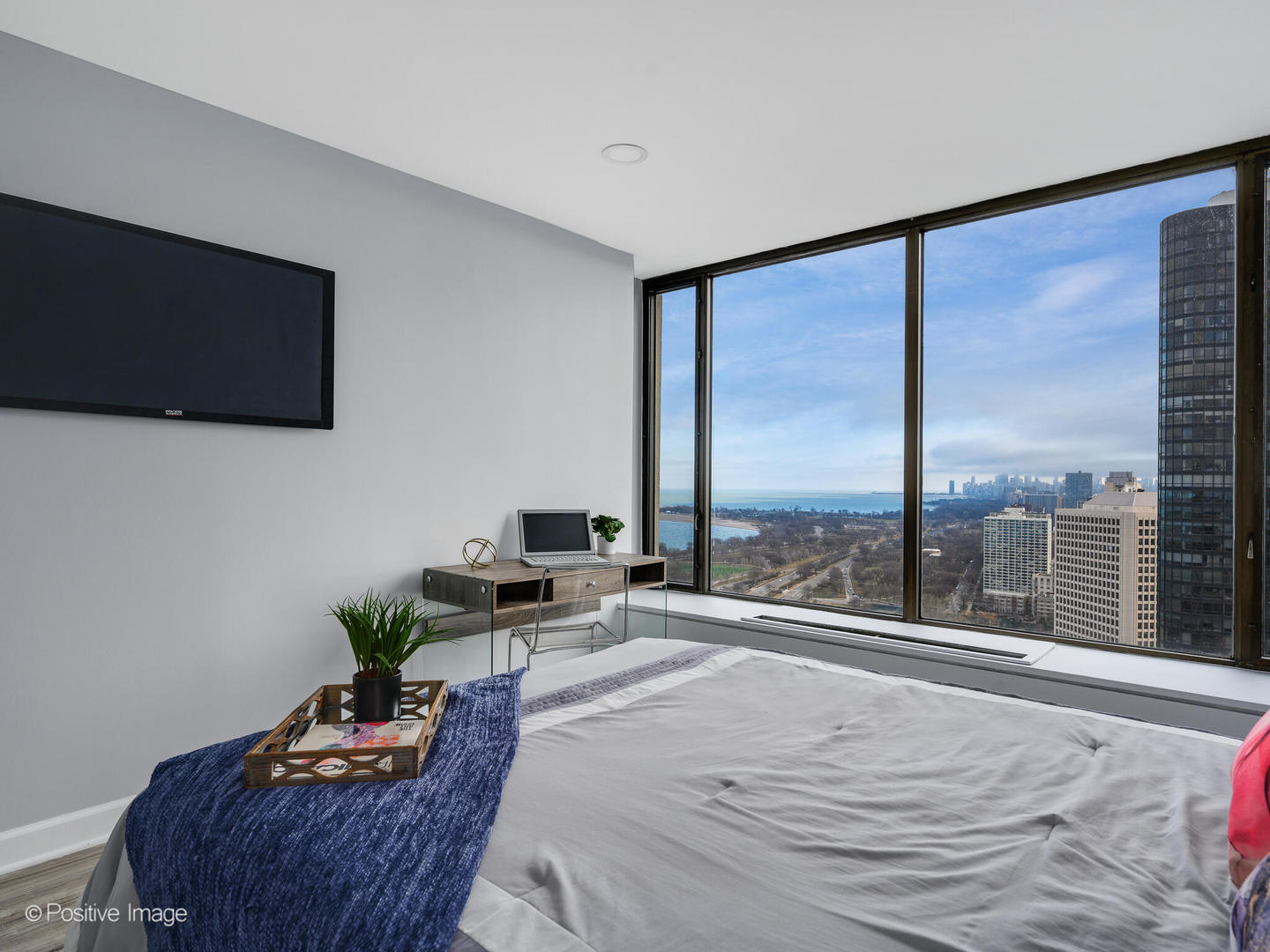 5455 North Sheridan Road, Unit 3906 Chicago, IL 60640 - Photo 15 of 24 a bedroom with furniture and a flat screen tv