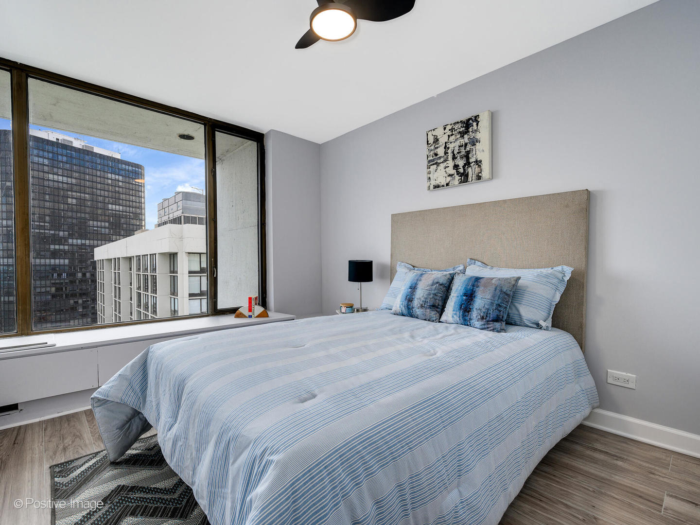 5455 North Sheridan Road, Unit 3906 Chicago, IL 60640 - Photo 16 of 24 a bedroom with a large bed and a large window