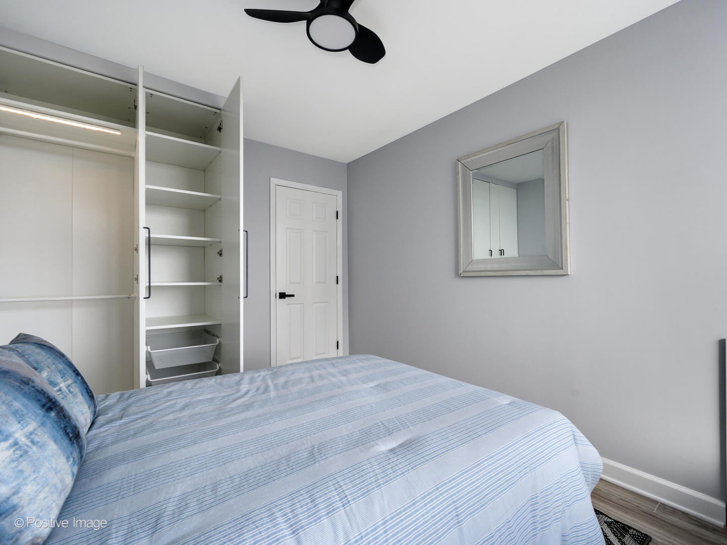 5455 North Sheridan Road, Unit 3906 Chicago, IL 60640 - Photo 18 of 24 a bedroom with a bed and a cabinets