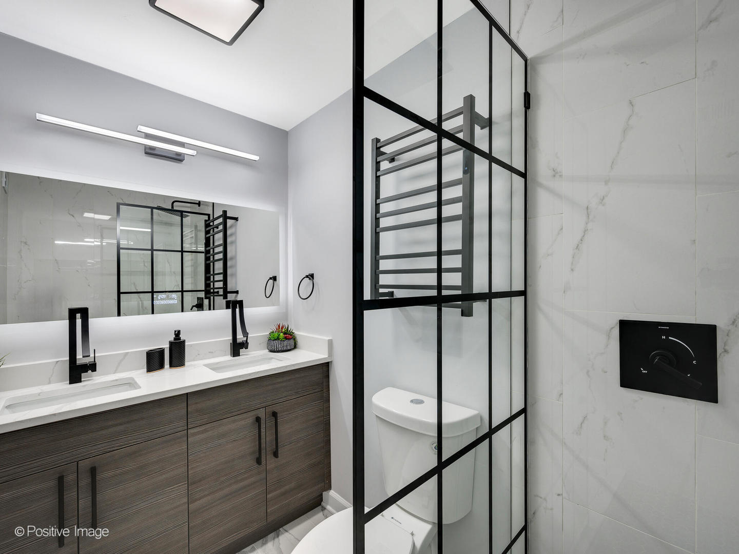 5455 North Sheridan Road, Unit 3906 Chicago, IL 60640 - Photo 19 of 24 a bathroom with a double vanity sink a mirror and shower