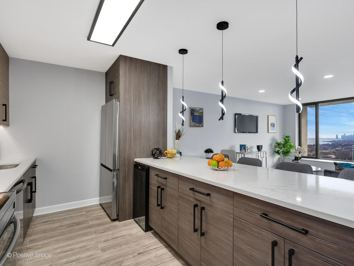 5455 North Sheridan Road, Unit 3906 Chicago, IL 60640 - Photo 4 of 24 a kitchen with stainless steel appliances a sink stove and refrigerator