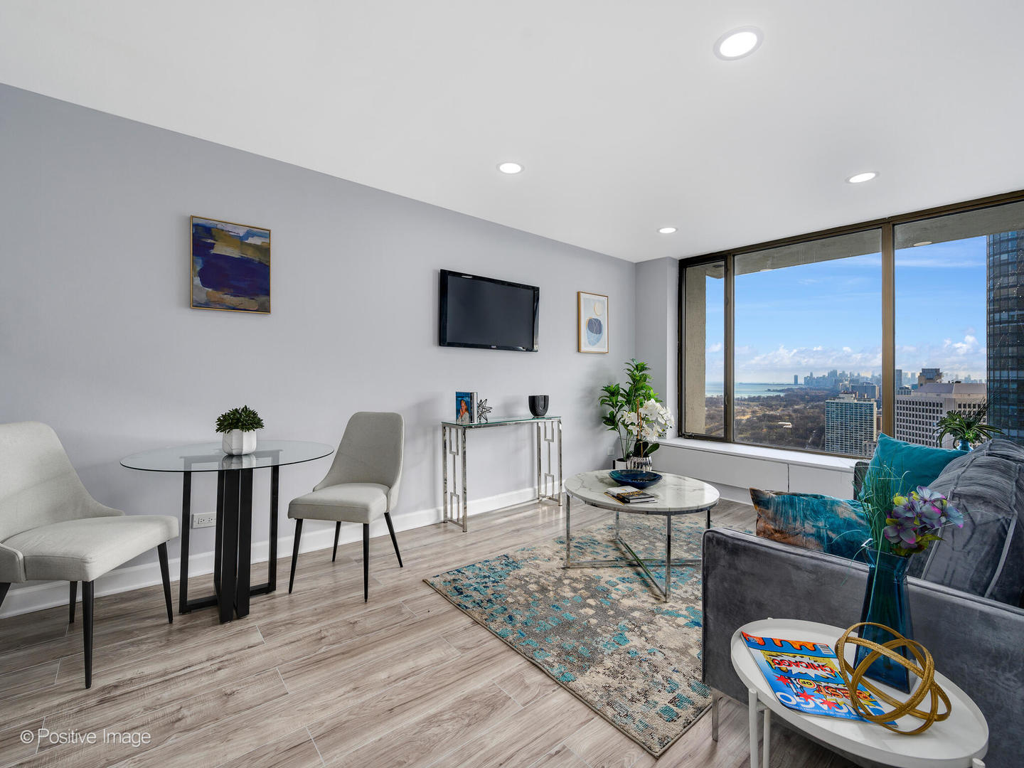 5455 North Sheridan Road, Unit 3906 Chicago, IL 60640 - Photo 7 of 24 a living room with furniture and a flat screen tv