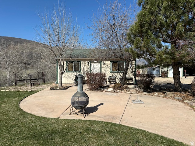 1454 East Little Sweden Road Heber City, UT 84032 - Photo 32 of 35 Back of house with a patio, an outdoor fire pit, a yard, and a mountain view
