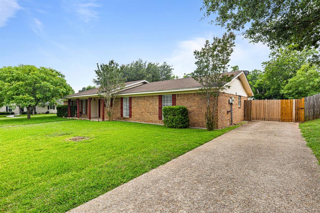 505 Pinewood Lane Hewitt, TX 76643 - Photo 34 of 38 Brick exterior residence featuring a covered front porch, concrete driveway, and a wood privacy fence
