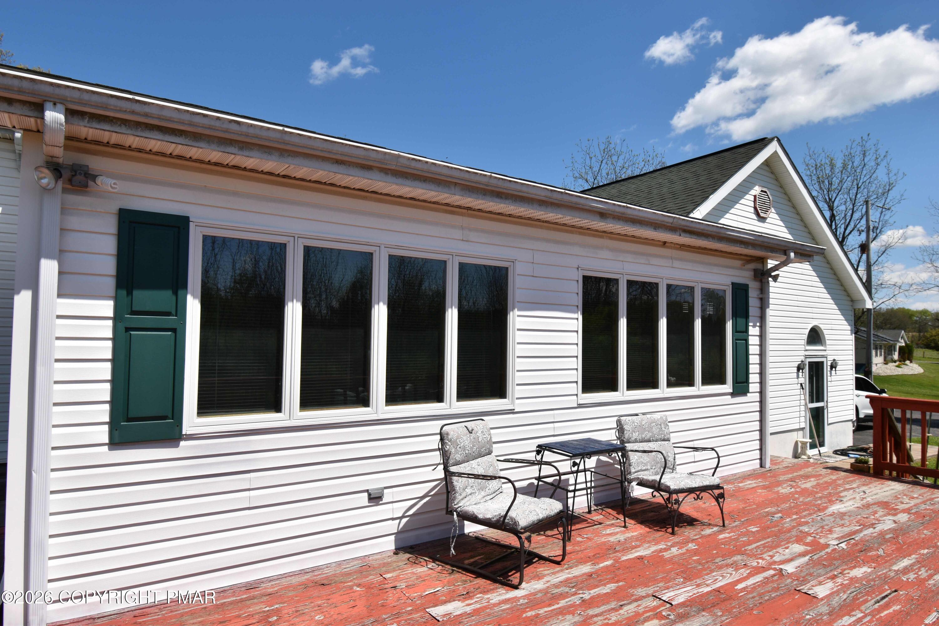 160 Quiet Valley Road Mount Bethel, PA 18343 - Photo 6 of 44 a view of a house with a barbeque and wooden bench