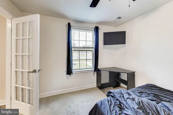 a bedroom with a bed and a window