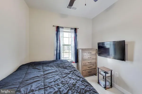 a bedroom with a bed and flat screen tv