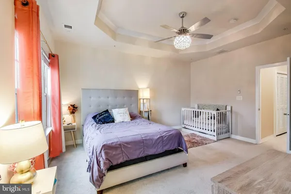 a bedroom with a large bed and a chandelier