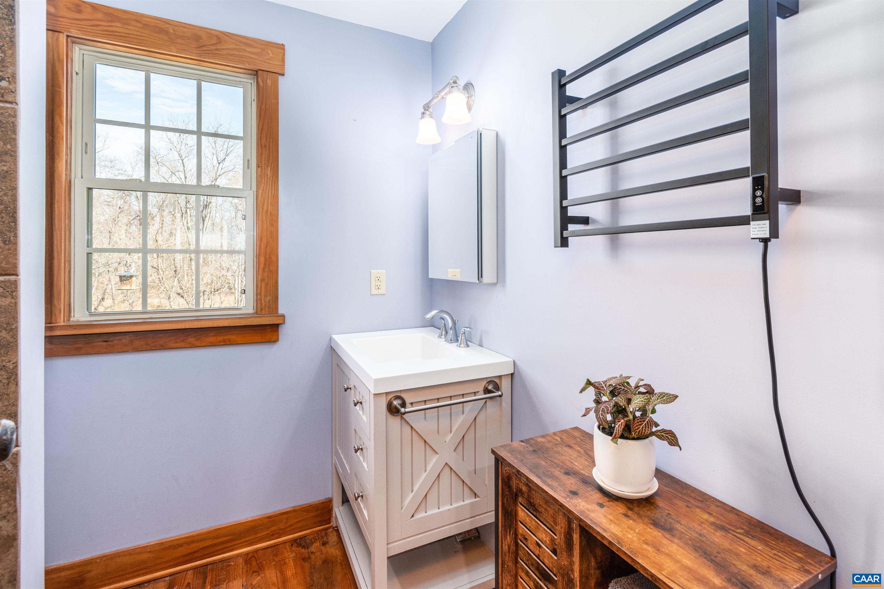 1067 Dry Bridge Road Charlottesville, VA 22903 - Photo 8 of 18 a room with a sink cabinets and wooden floor