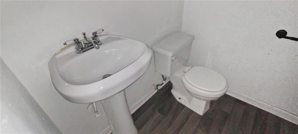 105 Anne Street Hampton, GA 30228 - Photo 6 of 15 a white toilet sitting next to a bathroom sink