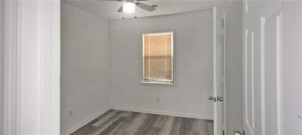 105 Anne Street Hampton, GA 30228 - Photo 8 of 15 a view of a small space with wooden floor and a window