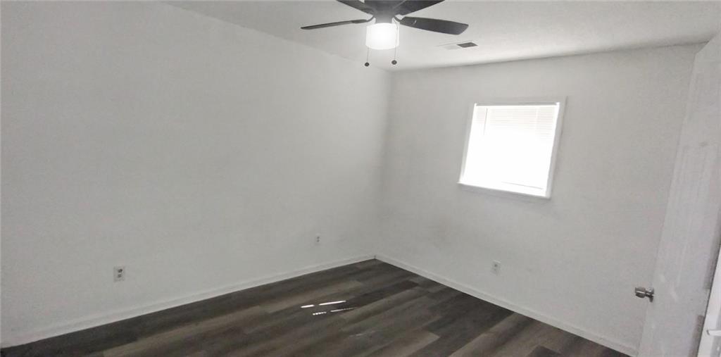 105 Anne Street Hampton, GA 30228 - Photo 9 of 15 an empty room with a window and ceiling fan