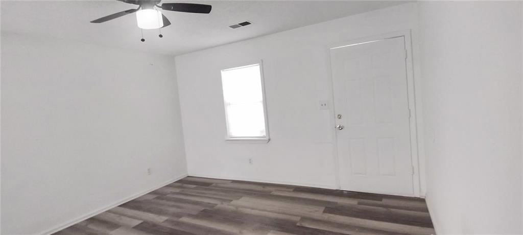 105 Anne Street Hampton, GA 30228 - Photo 10 of 15 an empty room with a window and a ceiling fan