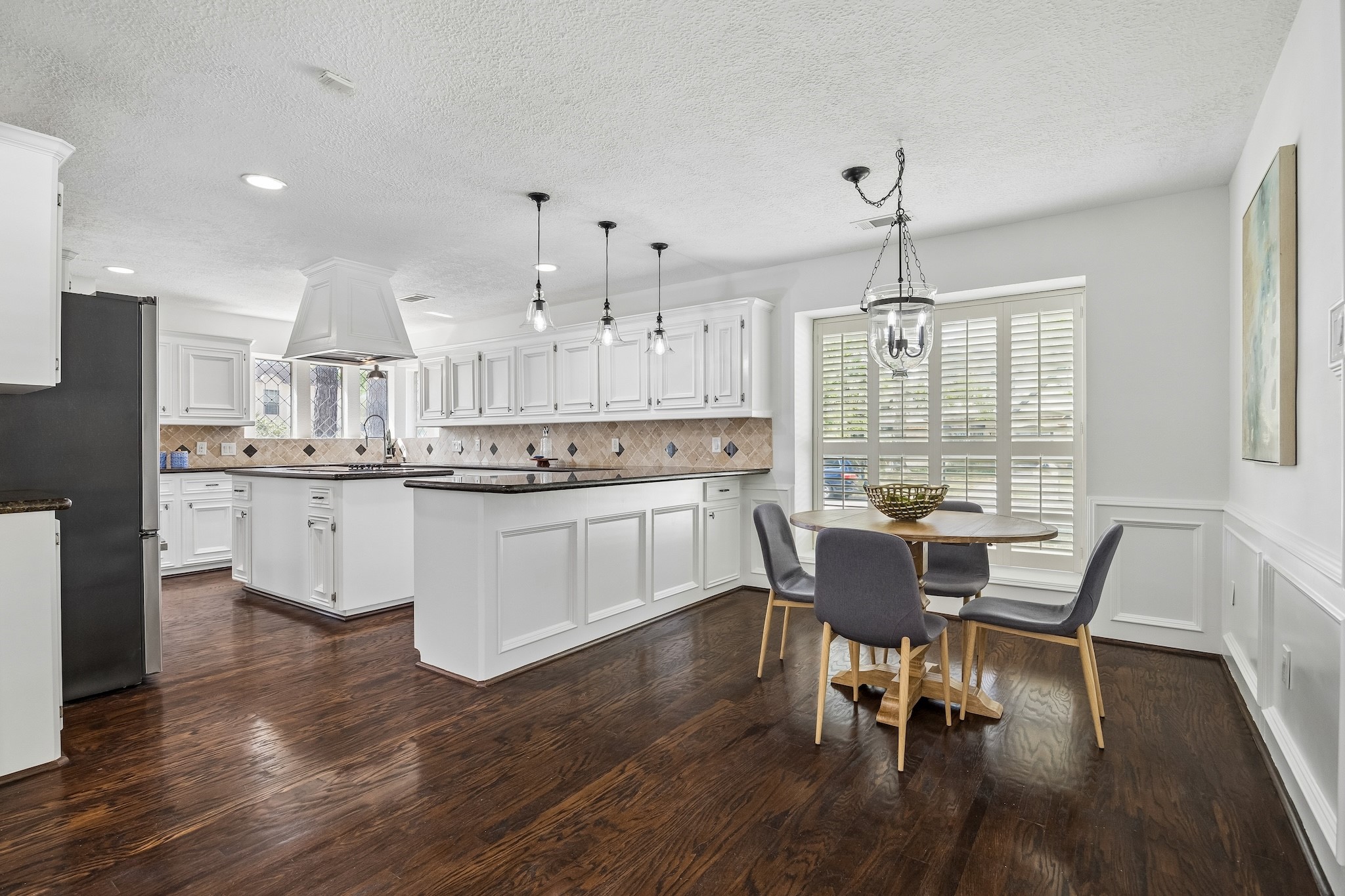 9718 Oxted Lane Spring, TX 77379 - Photo 10 of 38 The kitchen opens to a bright eat in nook with coordinating lantern chandelier